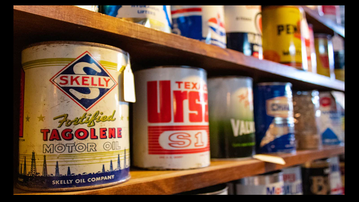 old oil and paint cans on shelf